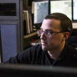 Air Methods dispatch employee sitting at desk.
